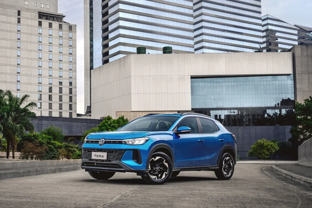Volkswagen Tera estreia com preços a partir de R$ 99.990 1 VW Tera azul posicionado em ambiente empresarial, com destaque para a grade frontal e faróis afilados.