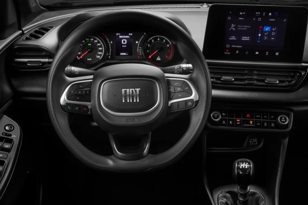 Fiat Pulse 2026: SUV compacto ganha design renovado com preços a partir de R$ 98.990 26 Volante e painel de instrumentos do Fiat Pulse Drive 2026 com comandos multifuncionais e mostradores analógicos.