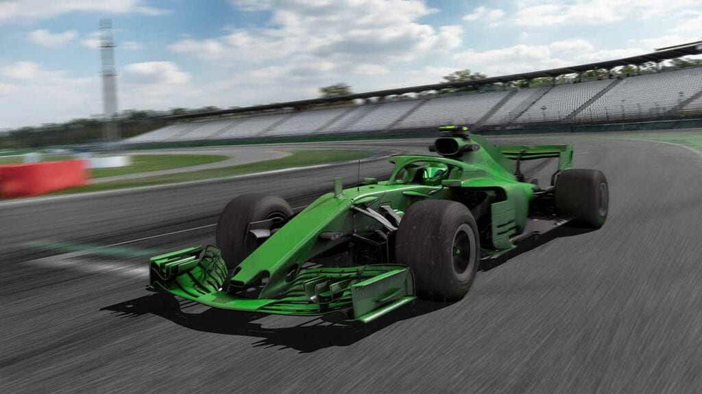 Carro de fórmula 1 na cor verde correndo em uma pista de corrida.